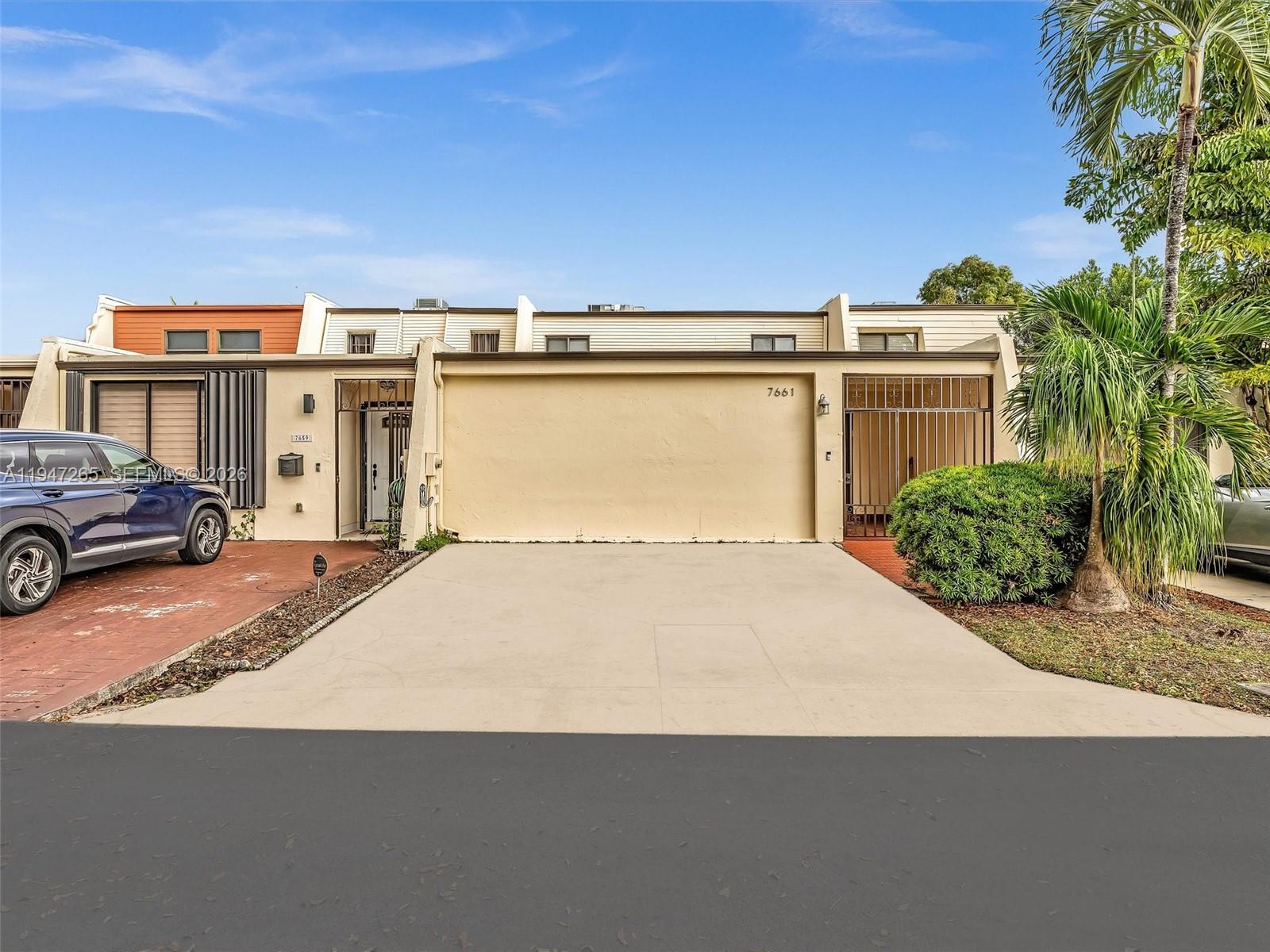7661 Southwest 102nd Place Miami, FL 33173 - Photo 1 of 51 a front view of a house with a yard