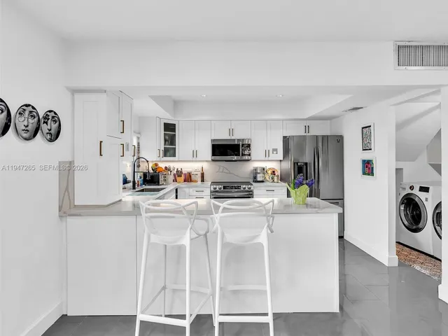 a living room filled with furniture and a potted plant