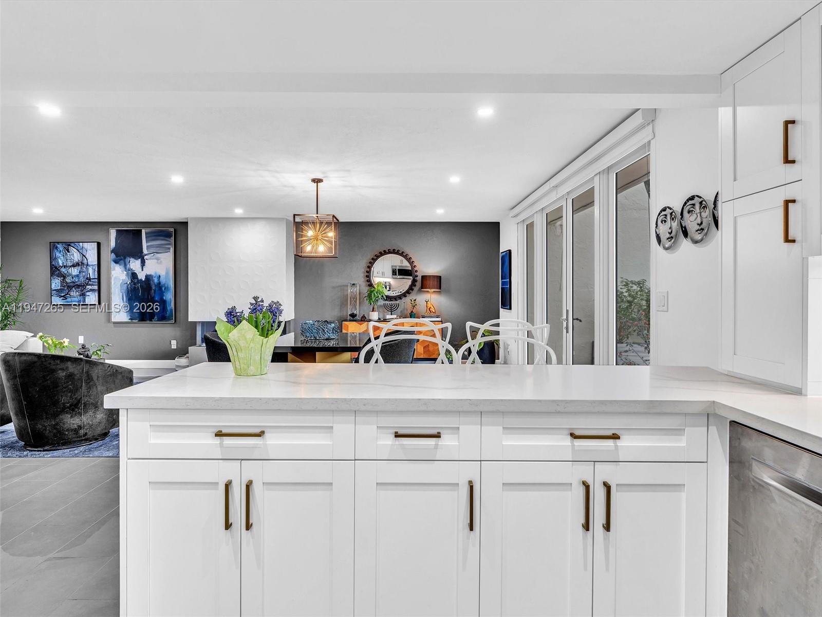 7661 Southwest 102nd Place Miami, FL 33173 - Photo 13 of 51 a kitchen with kitchen island granite countertop counter top space a sink and cabinets