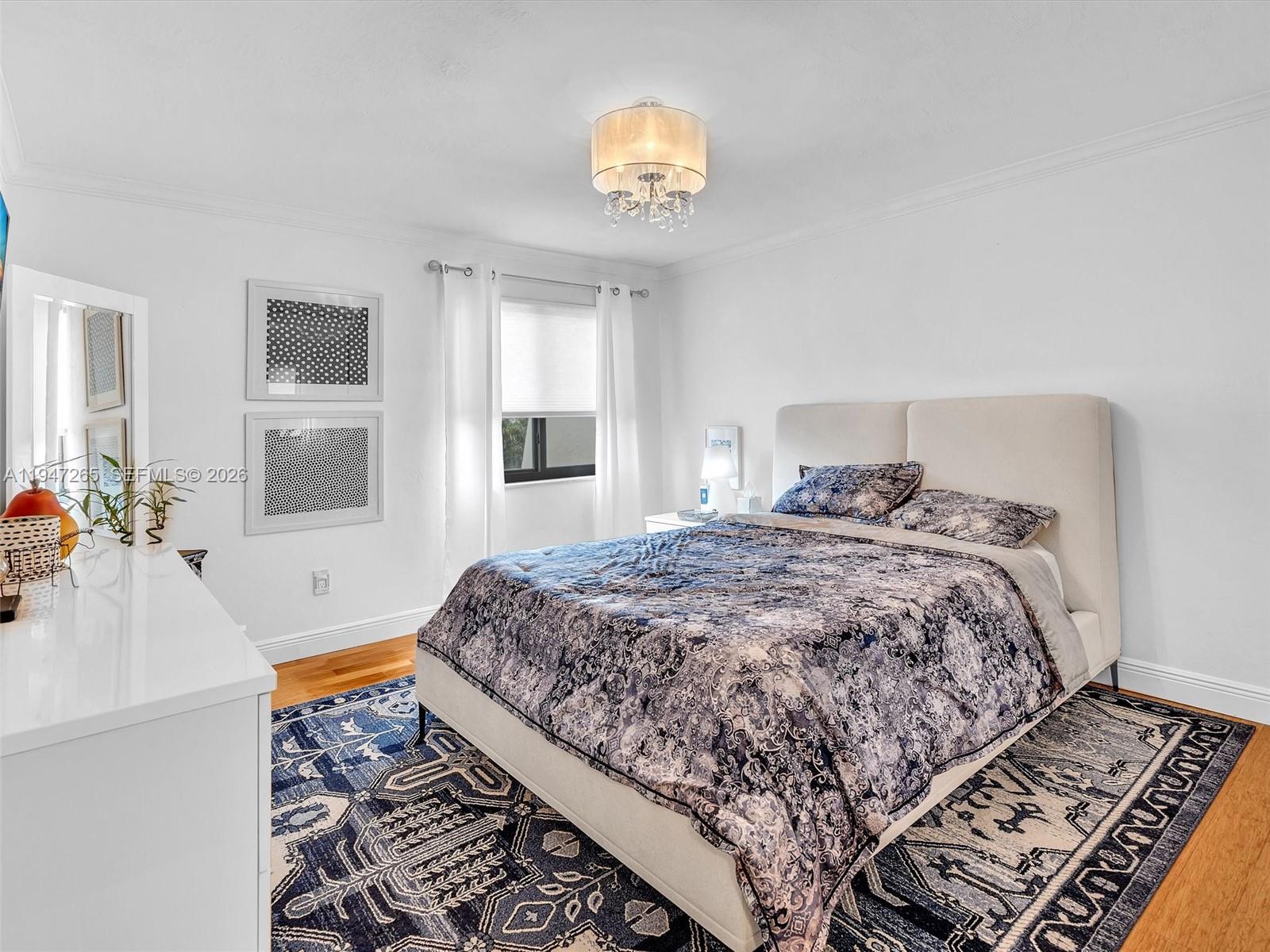 7661 Southwest 102nd Place Miami, FL 33173 - Photo 22 of 51 a bedroom with a large bed and a window