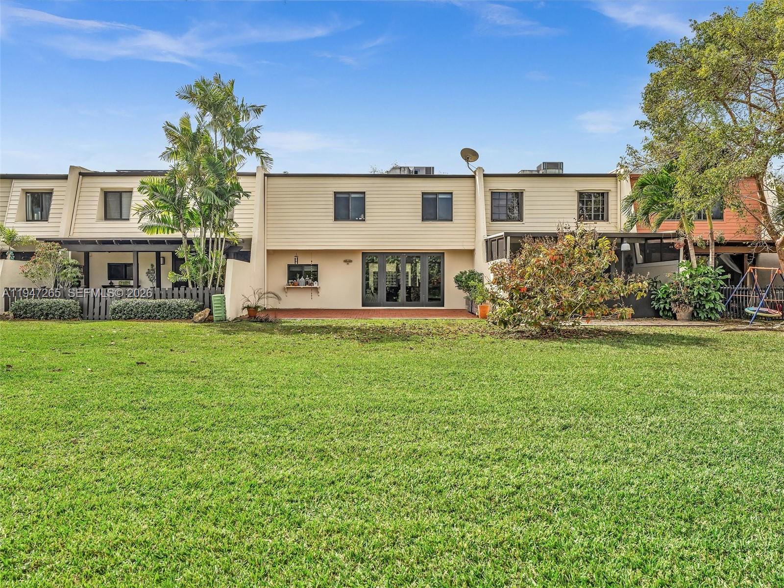 7661 Southwest 102nd Place Miami, FL 33173 - Photo 29 of 51 a front view of a house with garden and trees