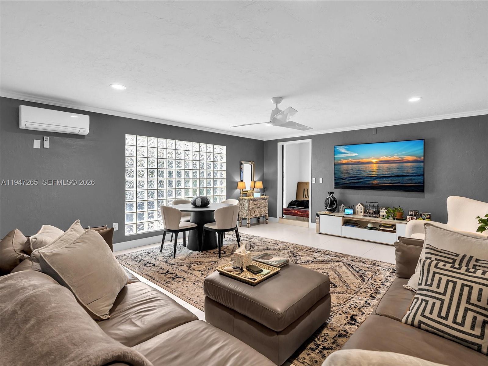 7661 Southwest 102nd Place Miami, FL 33173 - Photo 3 of 51 a living room with furniture and a flat screen tv