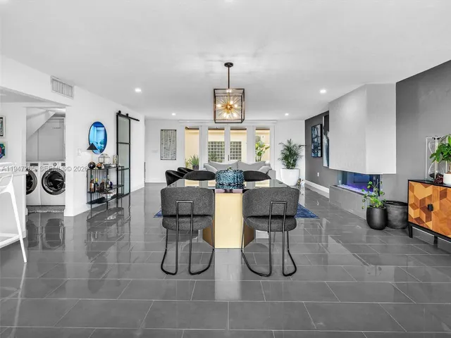 a large living room with furniture and a large window