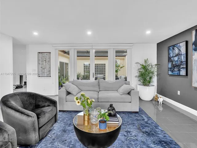 a living room with furniture and a potted plant