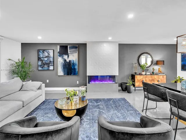 a kitchen with stainless steel appliances granite countertop a table and chairs in it