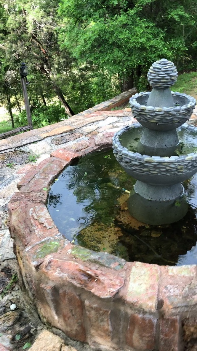 205 River Road Liberty Hill, TX 78642 - Photo 9 of 9 A tranquil stone fountain adds charm to this verdant, private outdoor space.