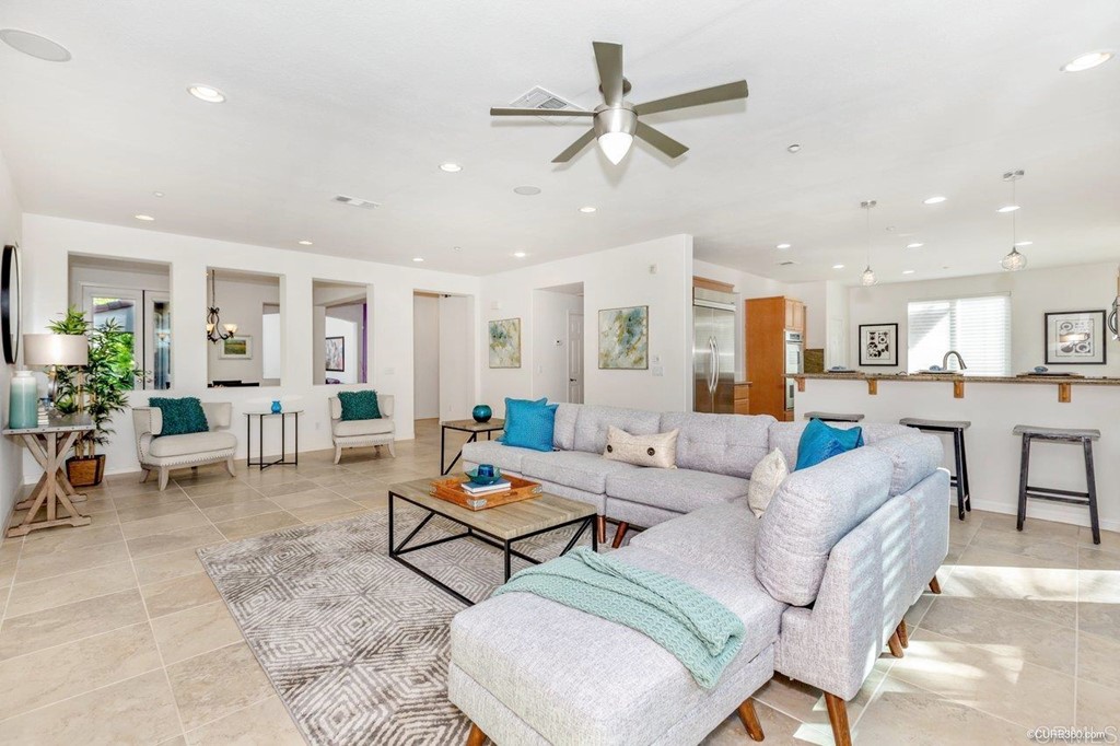 a living room with furniture and a view of kitchen