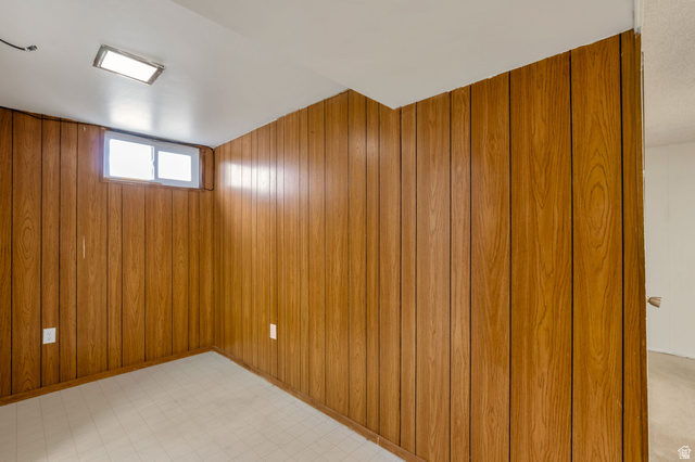 447 550 South Bountiful, UT 84010 - Photo 15 of 25 Room featuring wood-paneled walls, a white ceiling, and light-colored flooring