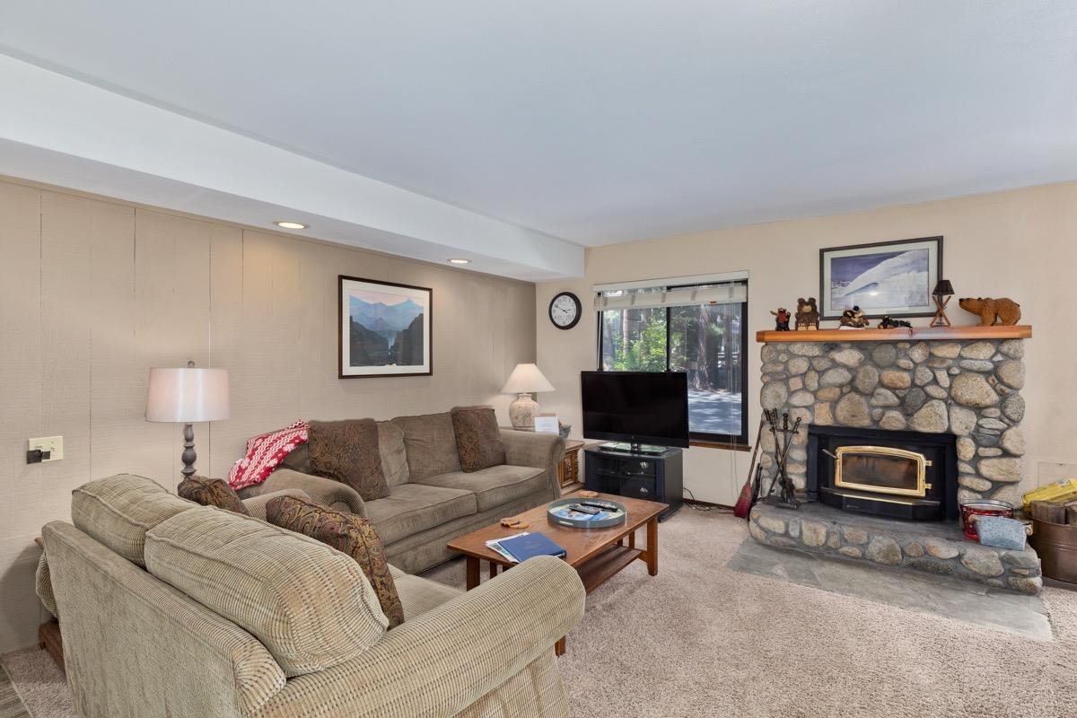 Carpeted living area with recessed lighting