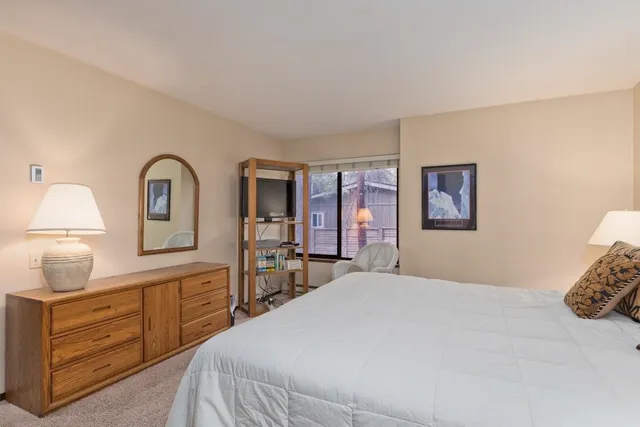 a bedroom with a bed and a dresser