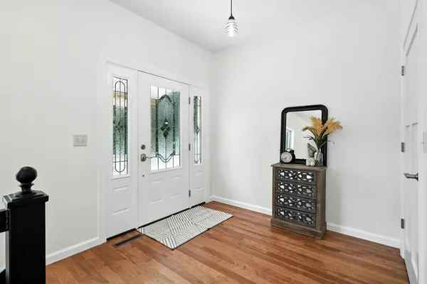 a view of room with window and wooden floor