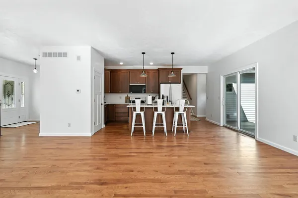 a view of kitchen with dining room and wooden floor