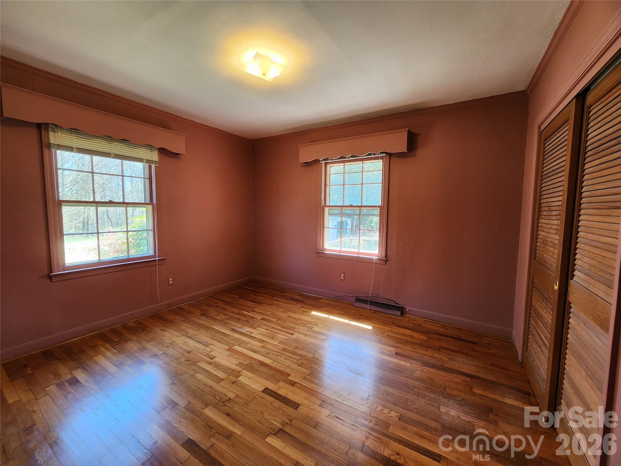 217 St John Street Dallas, NC 28034 - Photo 11 of 34 an empty room with wooden floor and windows