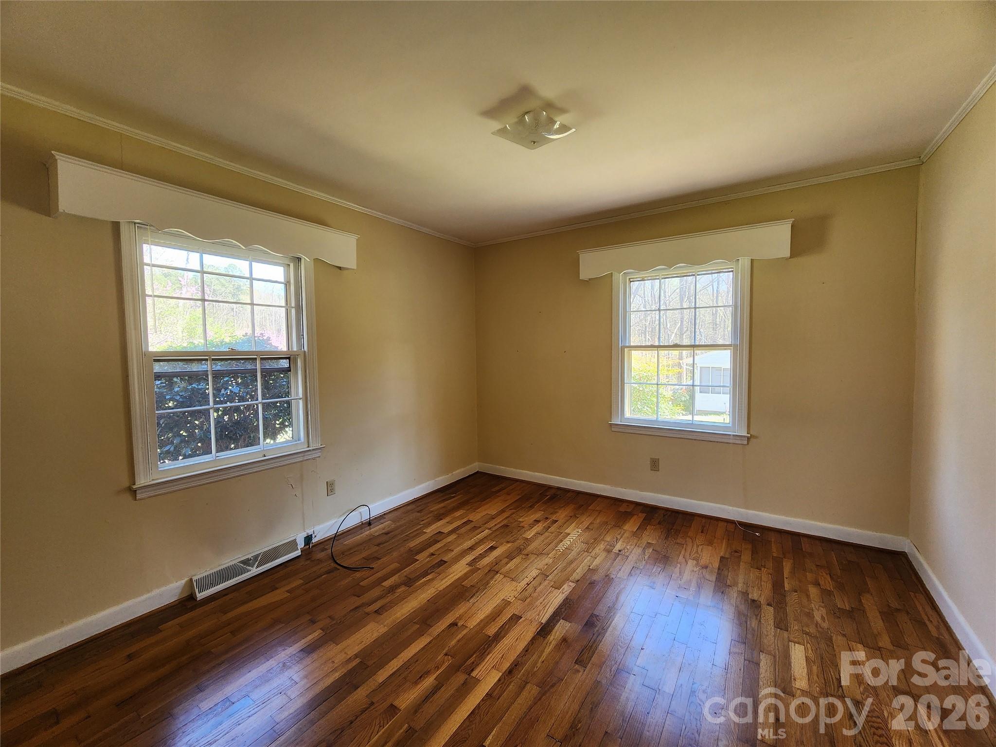 217 St John Street Dallas, NC 28034 - Photo 12 of 34 a view of an empty room with wooden floor and a window