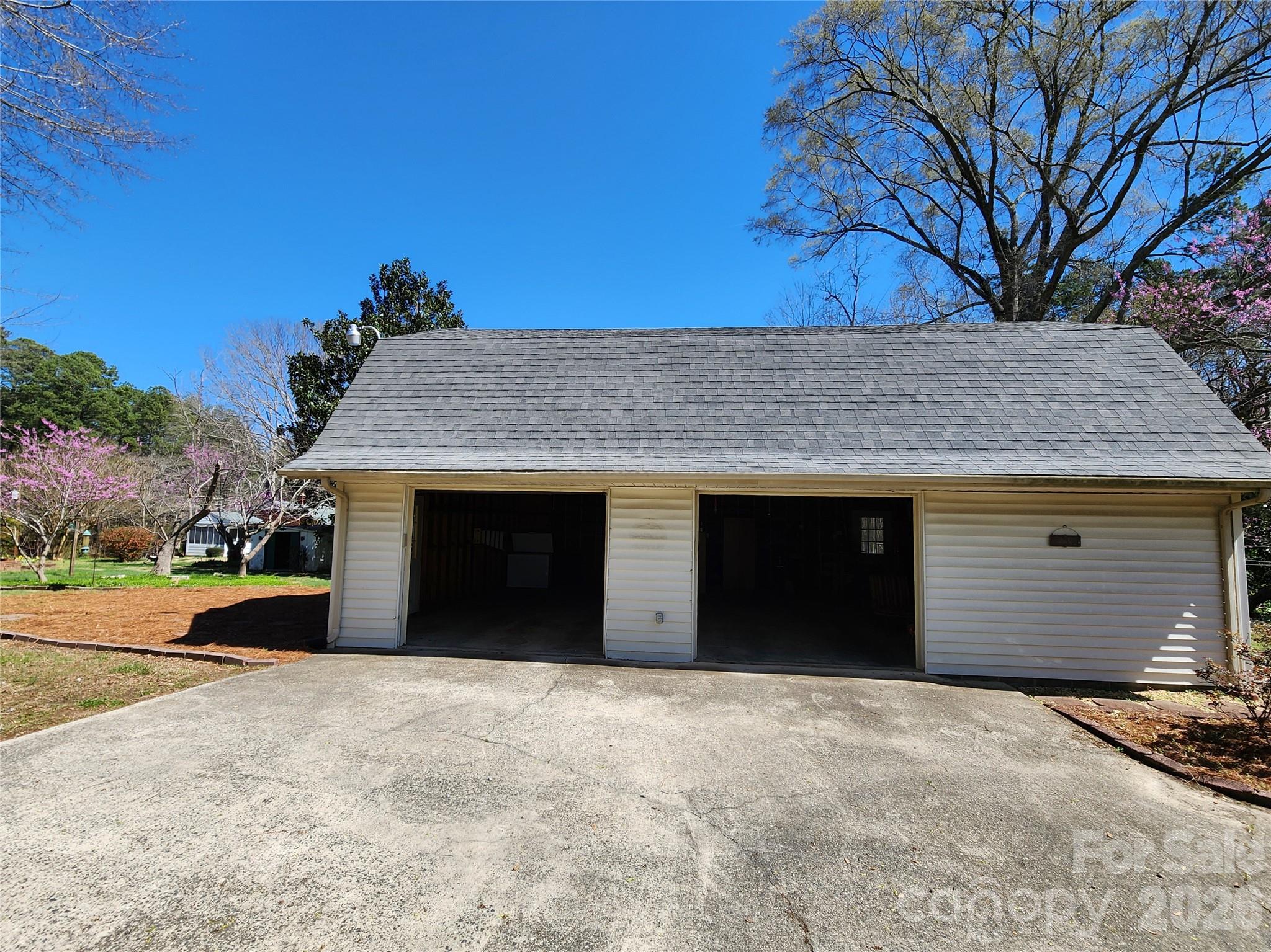 217 St John Street Dallas, NC 28034 - Photo 19 of 34 a front view of a house with a yard and garage