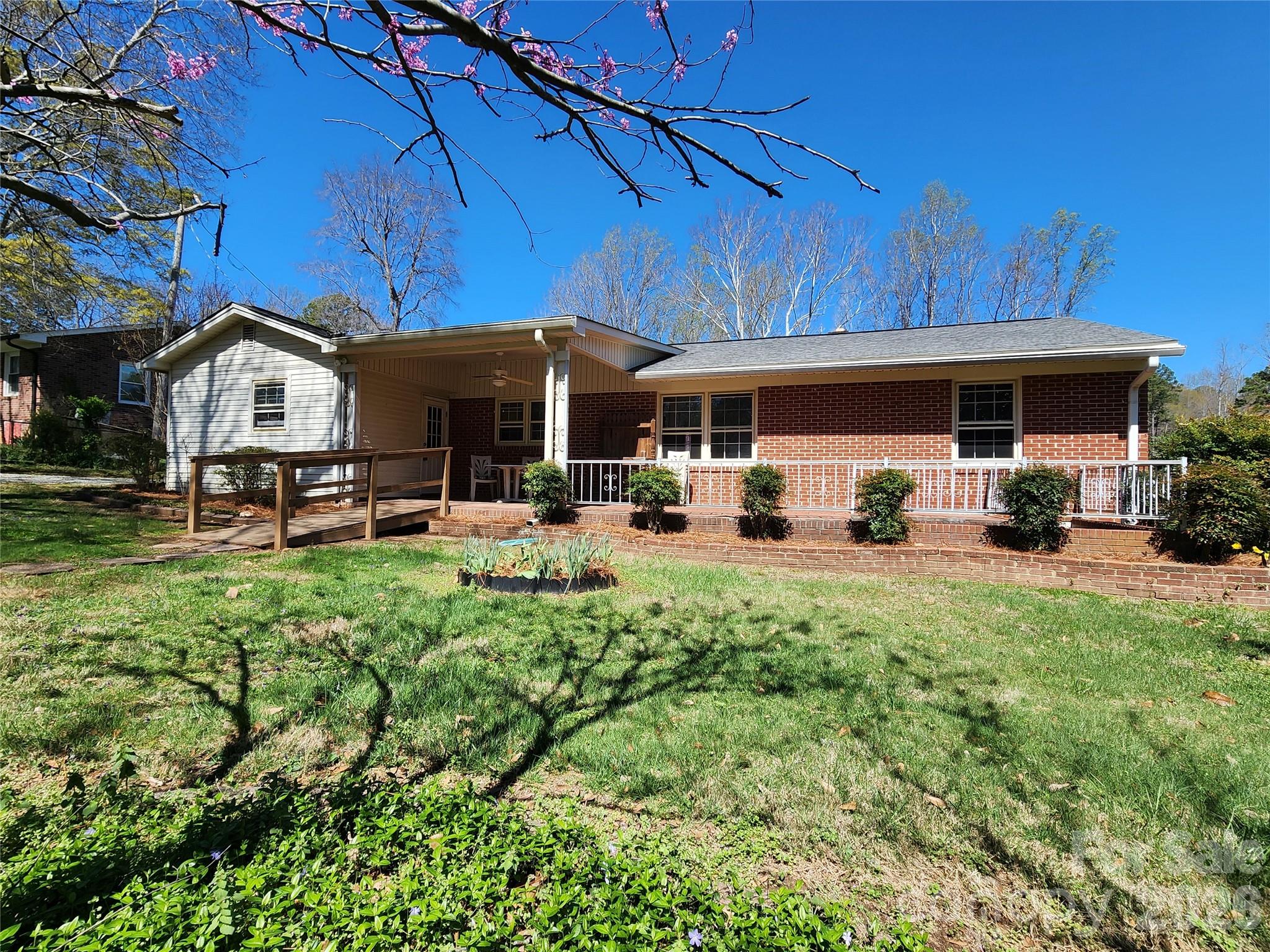 217 St John Street Dallas, NC 28034 - Photo 3 of 34 a view of a house with a yard patio and fire pit