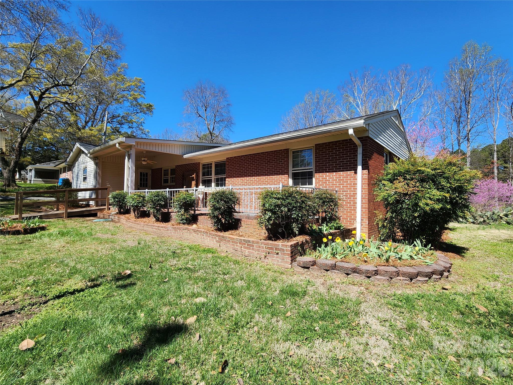 217 St John Street Dallas, NC 28034 - Photo 6 of 34 a view of a house with a yard and sitting area