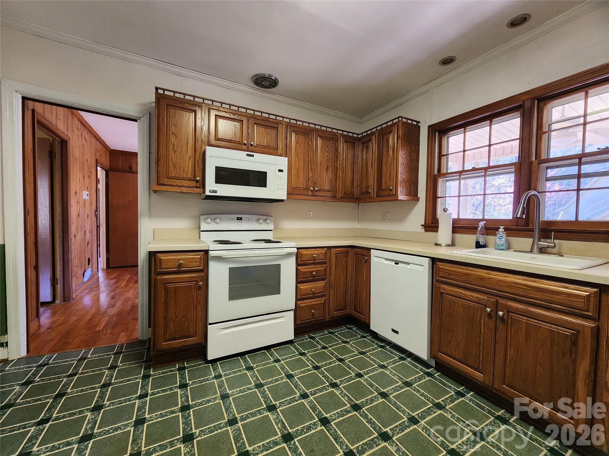 217 St John Street Dallas, NC 28034 - Photo 8 of 34 a kitchen with a stove a sink and a microwave