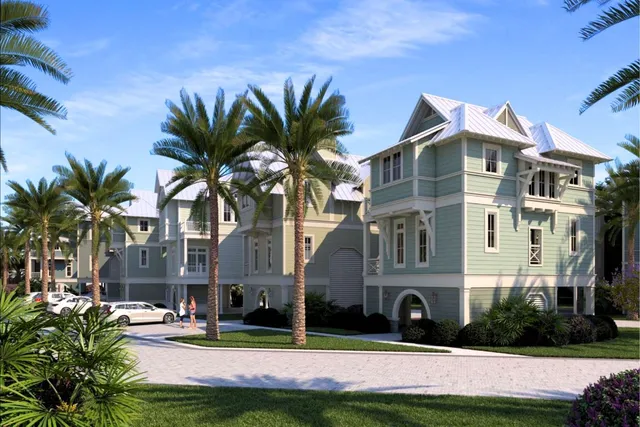 a front view of multiple houses with yard