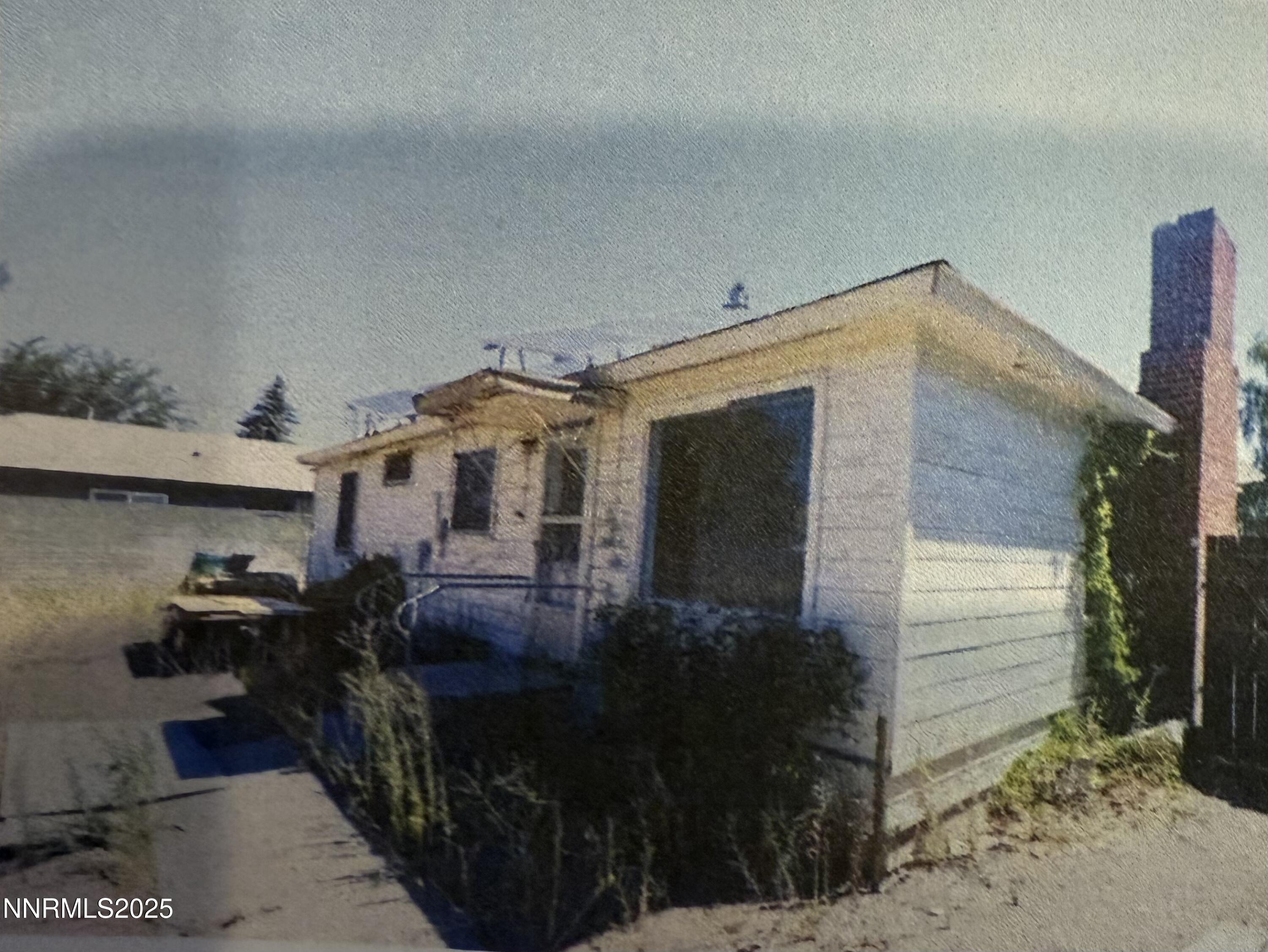 1075 Memory Lane Reno, NV 89509 - Photo 1 of 11 a backyard of a house with barbeque oven and outdoor seating