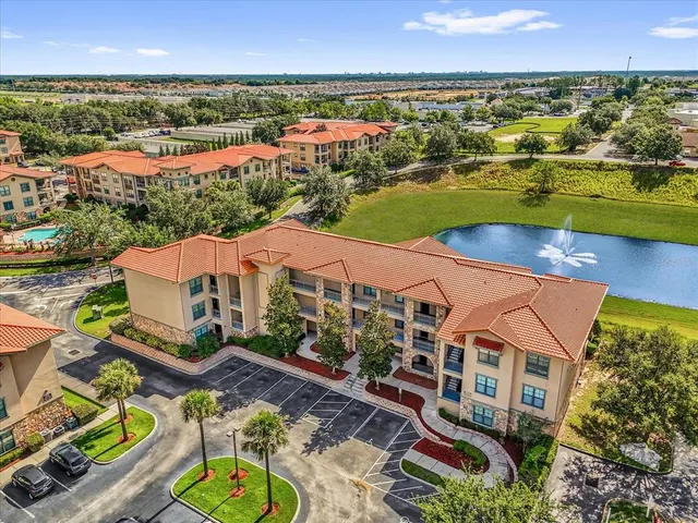 an aerial view of residential houses with outdoor space and ocean view