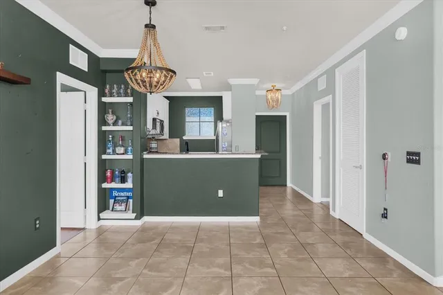 a living room with furniture a chandelier and a large window