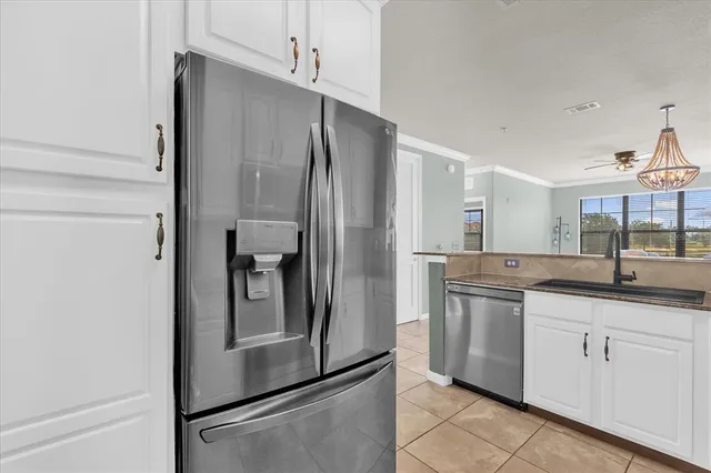 a kitchen with granite countertop white cabinets and a stove