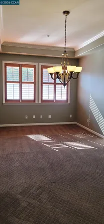 a view of room with window and a ceiling fan