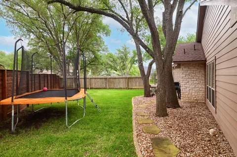 a backyard of a house with table and chairs