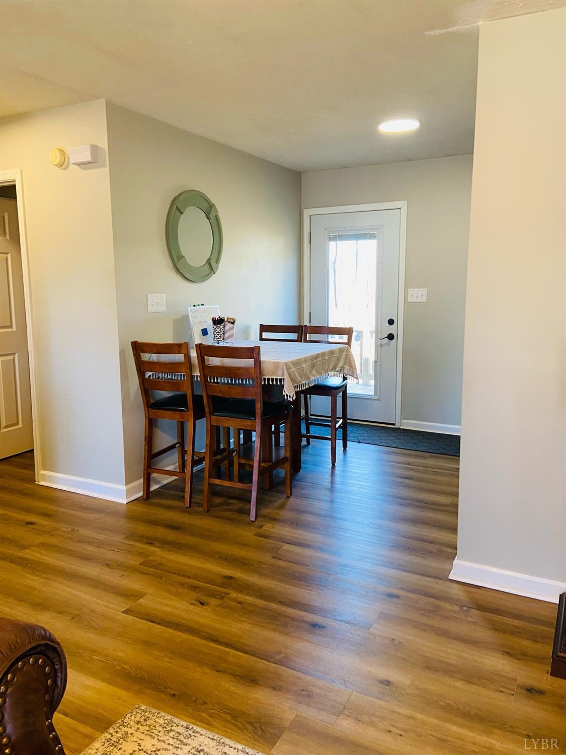 498 Stonewall Road Concord, VA 24538 - Photo 15 of 30 a view of a dining room with furniture and wooden floor