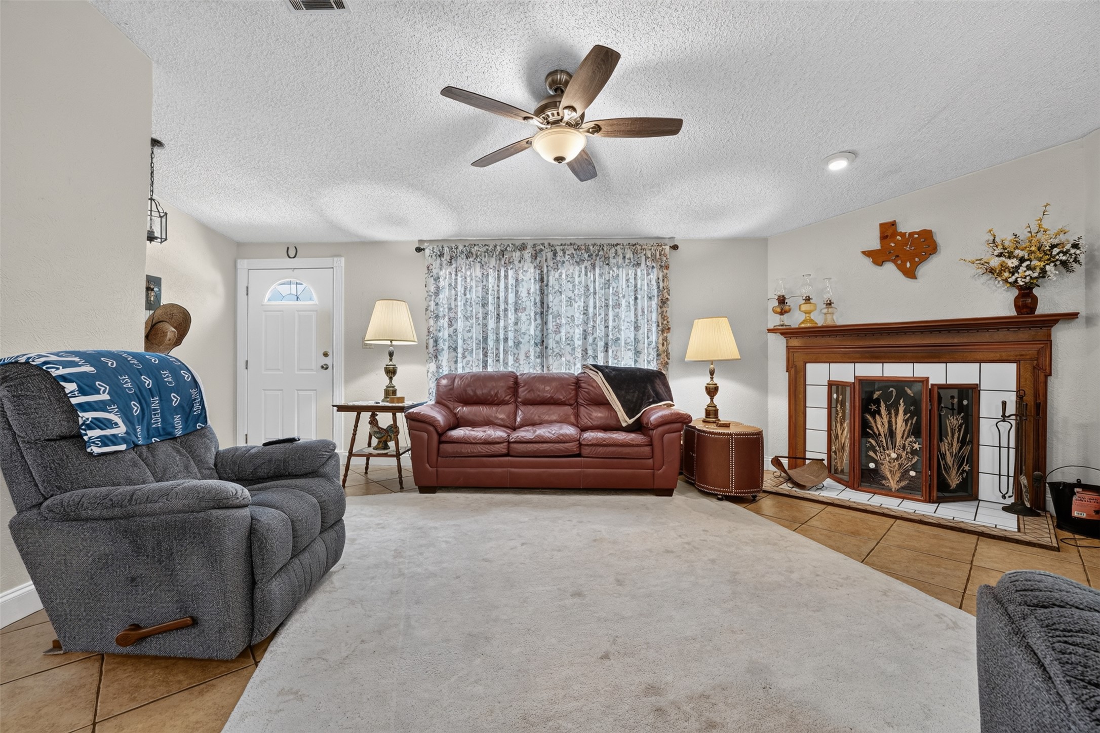 317 Rae Lane Jarrell, TX 76537 - Photo 26 of 40 A welcoming living area featuring a traditional fireplace and a comfortable layout.
