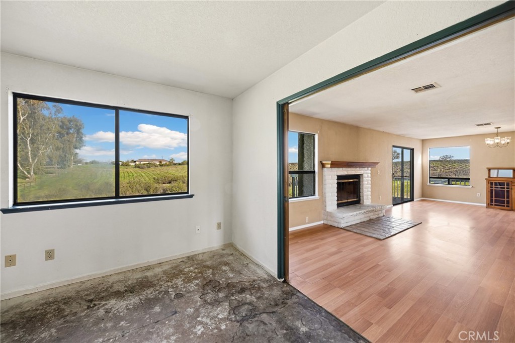 6980 Cabernet Place Paso Robles, CA 93446 - Photo 14 of 30 a view of empty room with wooden floor and fireplace