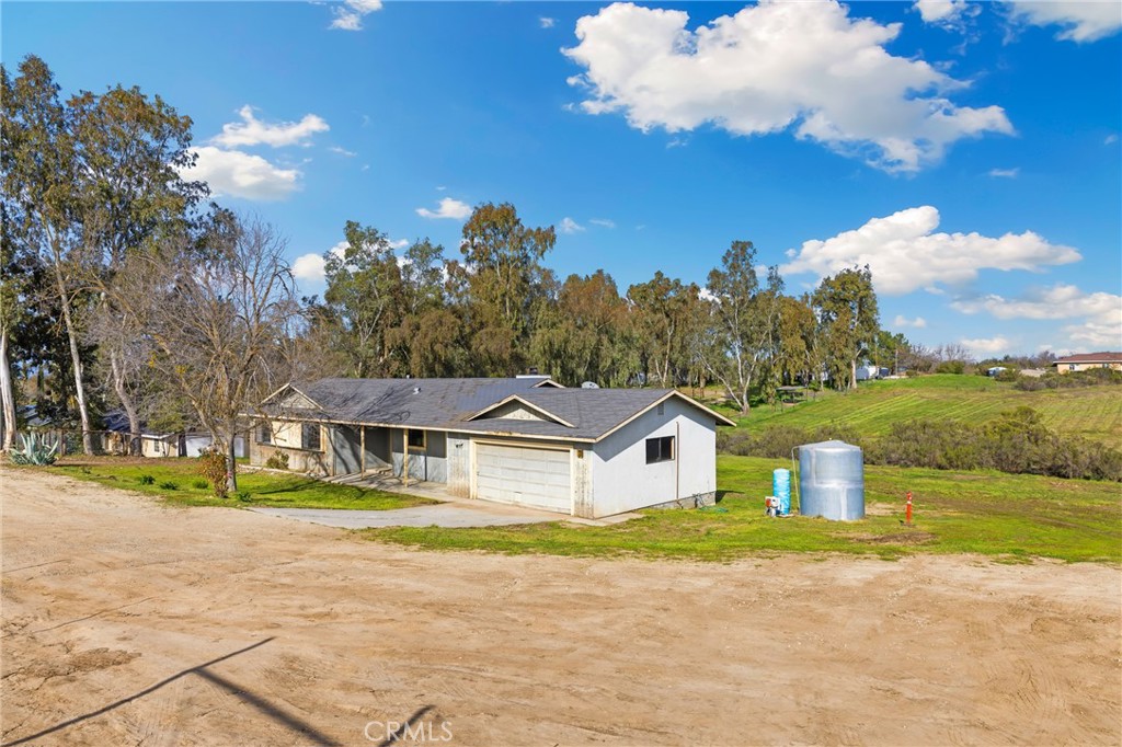6980 Cabernet Place Paso Robles, CA 93446 - Photo 23 of 30 a front view of a house with a yard and swimming pool