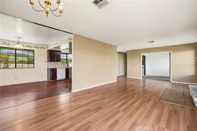 a view of a kitchen with wooden floor and a ceiling fan