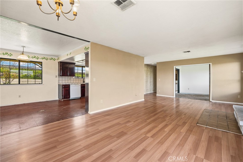 6980 Cabernet Place Paso Robles, CA 93446 - Photo 8 of 30 a view of a kitchen with wooden floor and a ceiling fan