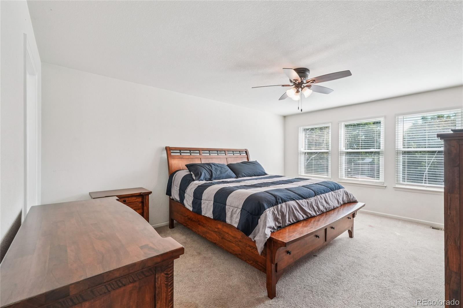 9230 Cook Street Thornton, CO 80229 - Photo 14 of 34 a bed sitting in a spacious bedroom next to a window