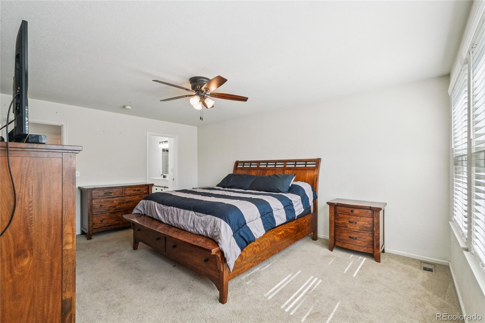 9230 Cook Street Thornton, CO 80229 - Photo 15 of 34 a bedroom with a bed and a flat screen tv