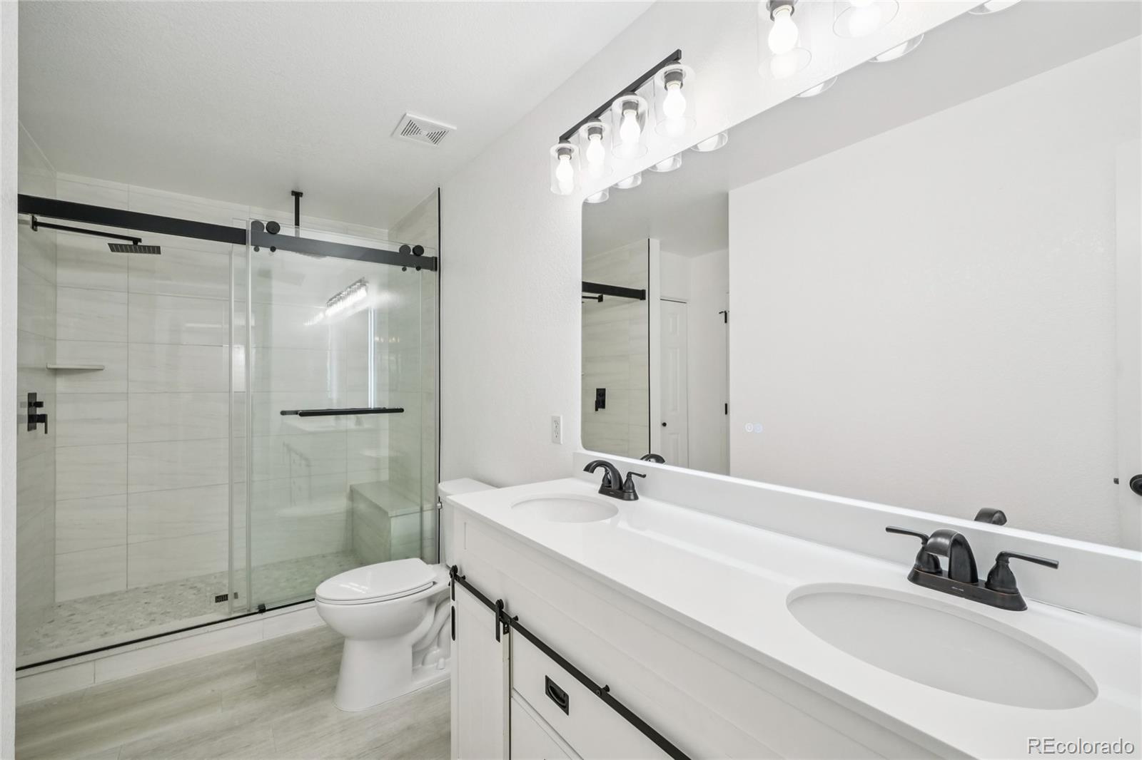 9230 Cook Street Thornton, CO 80229 - Photo 16 of 34 a bathroom with a sink toilet and shower