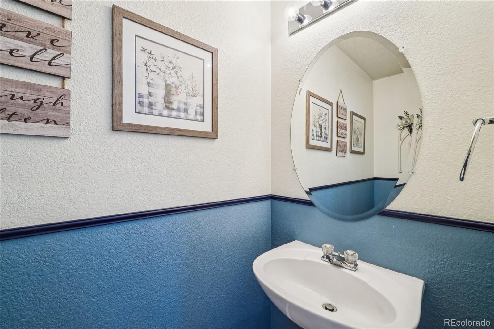 9230 Cook Street Thornton, CO 80229 - Photo 18 of 34 a bathroom with a sink and a mirror