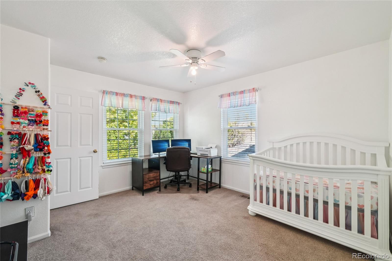 9230 Cook Street Thornton, CO 80229 - Photo 25 of 34 a bedroom with furniture a baby crib and a window