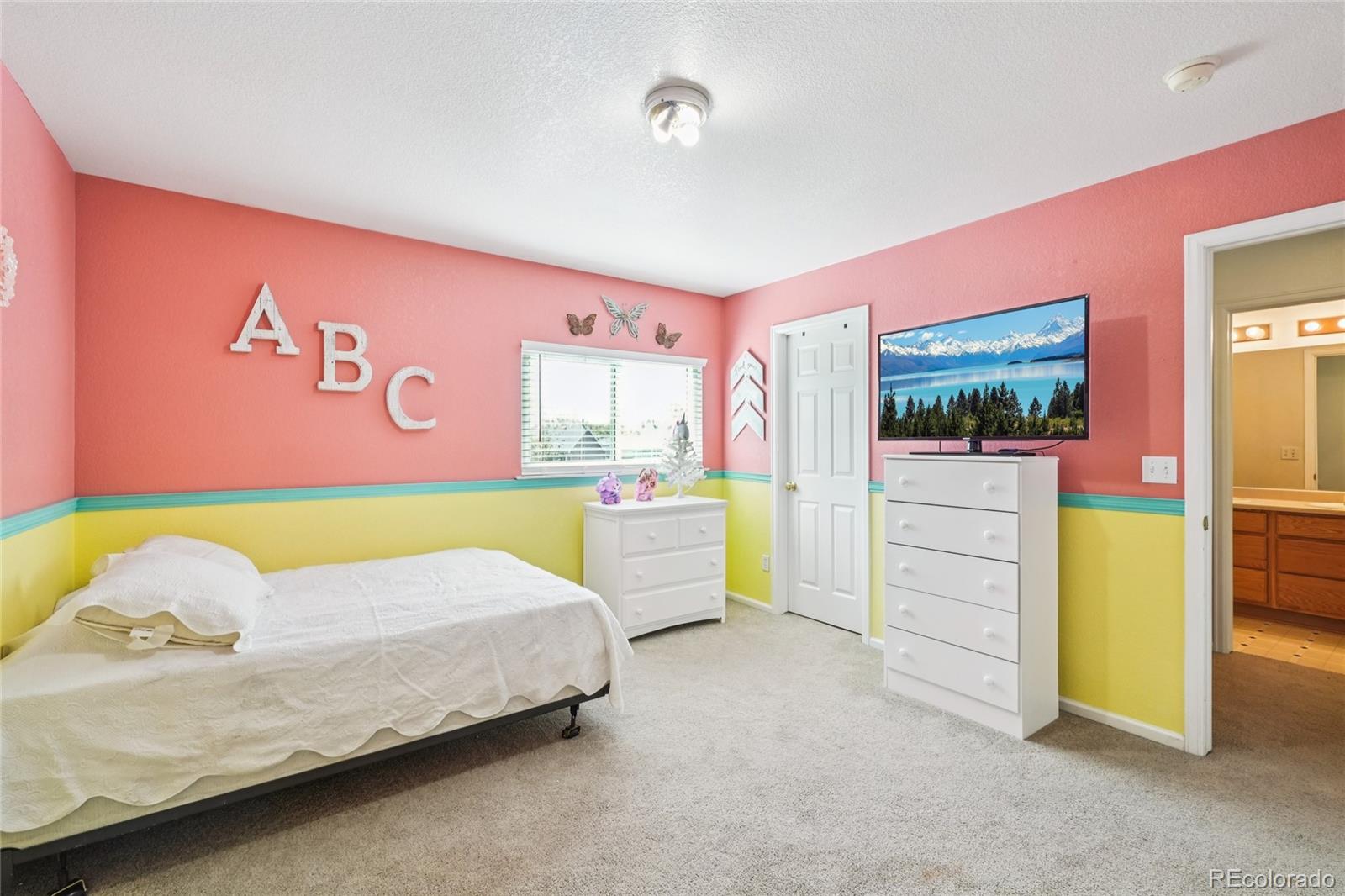 9230 Cook Street Thornton, CO 80229 - Photo 28 of 34 a bed room with a bed and a chair