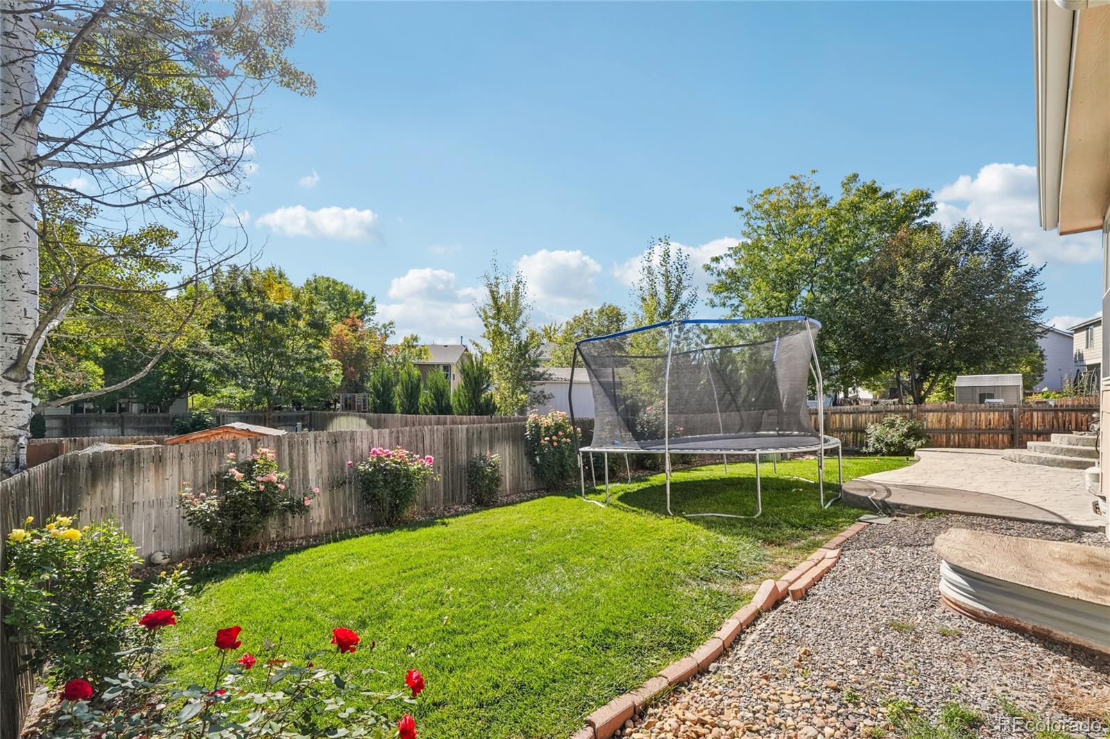 9230 Cook Street Thornton, CO 80229 - Photo 33 of 34 a view of a backyard with wooden fence and a bench