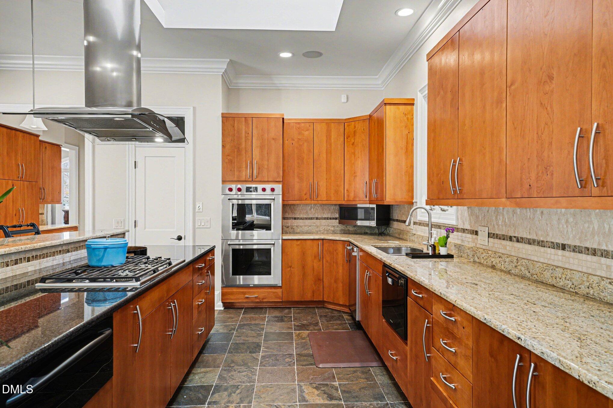 3207 Sussex Road Raleigh, NC 27607 - Photo 15 of 53 a large kitchen with stainless steel appliances granite countertop a sink stove and cabinets