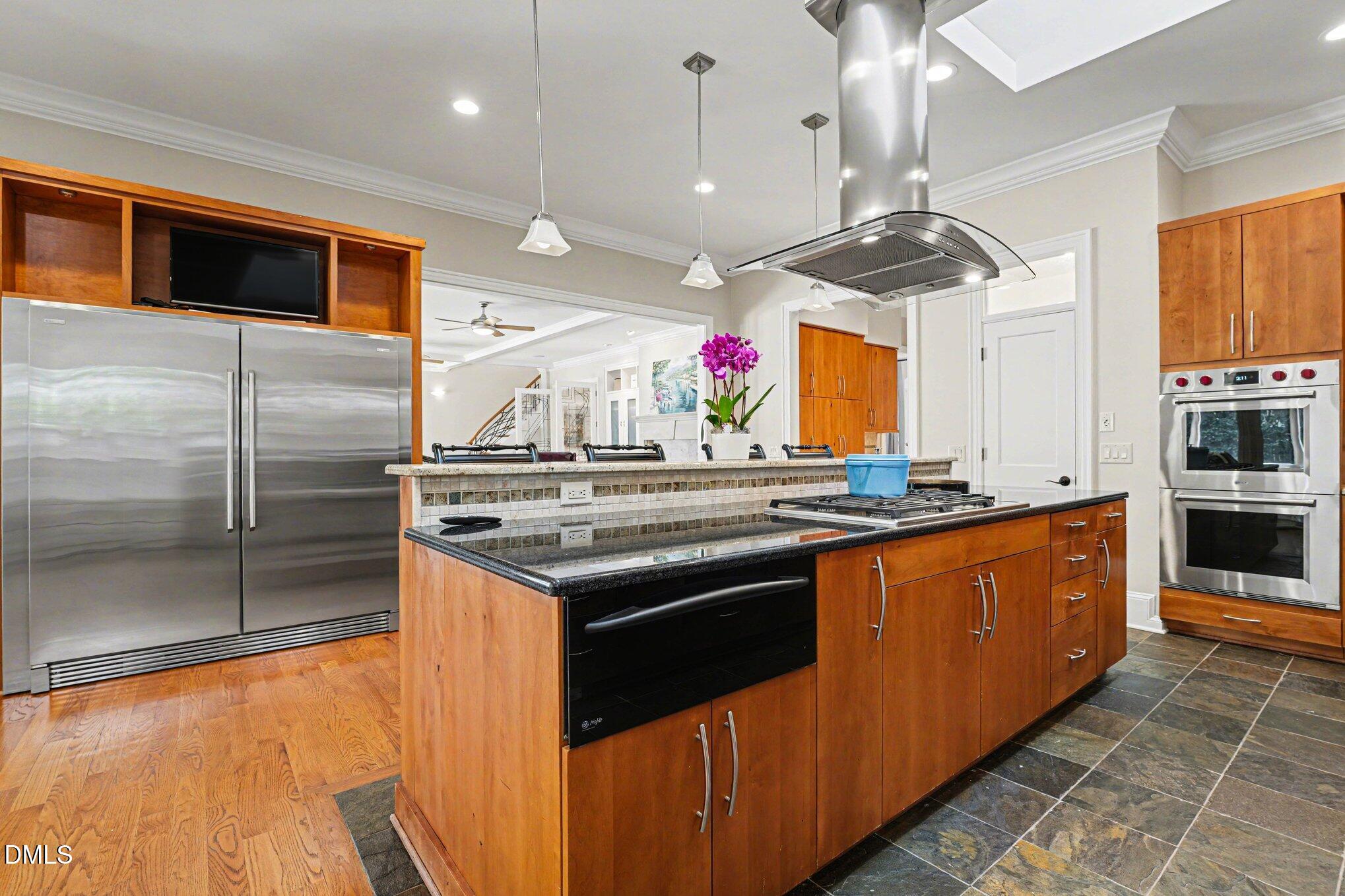 3207 Sussex Road Raleigh, NC 27607 - Photo 16 of 53 a kitchen with stainless steel appliances granite countertop a sink and a refrigerator