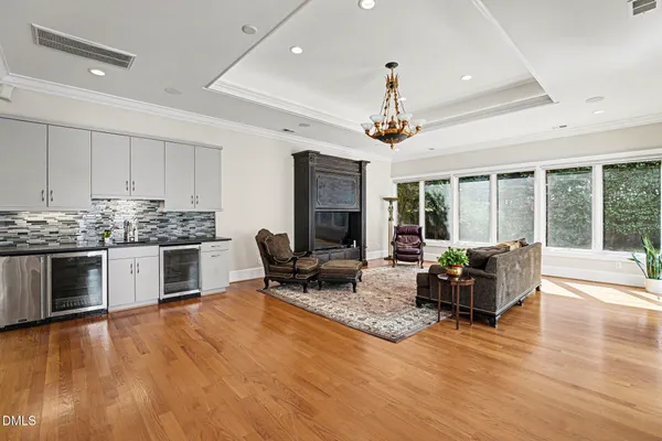 a living room with furniture large window and flat screen tv