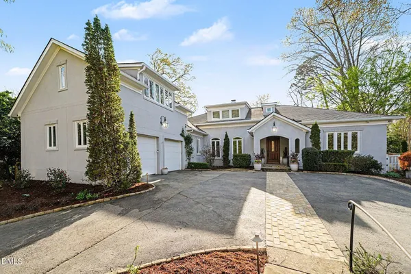a view of a white house with large windows