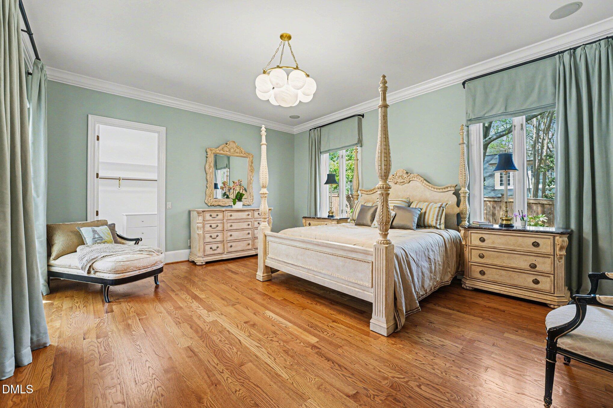 3207 Sussex Road Raleigh, NC 27607 - Photo 21 of 53 a bedroom with a bed and wooden floor