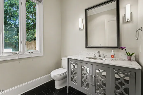 a bathroom with a toilet sink and mirror