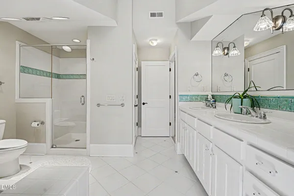 a spacious bathroom with a granite countertop sink mirror and a shower