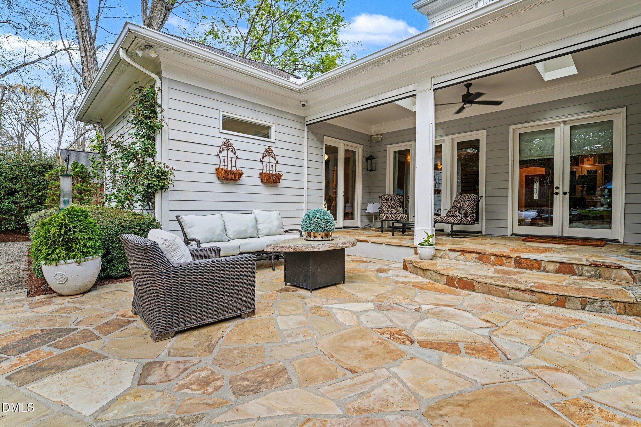 3207 Sussex Road Raleigh, NC 27607 - Photo 48 of 53 a view of a patio with couches table and chairs and potted plants